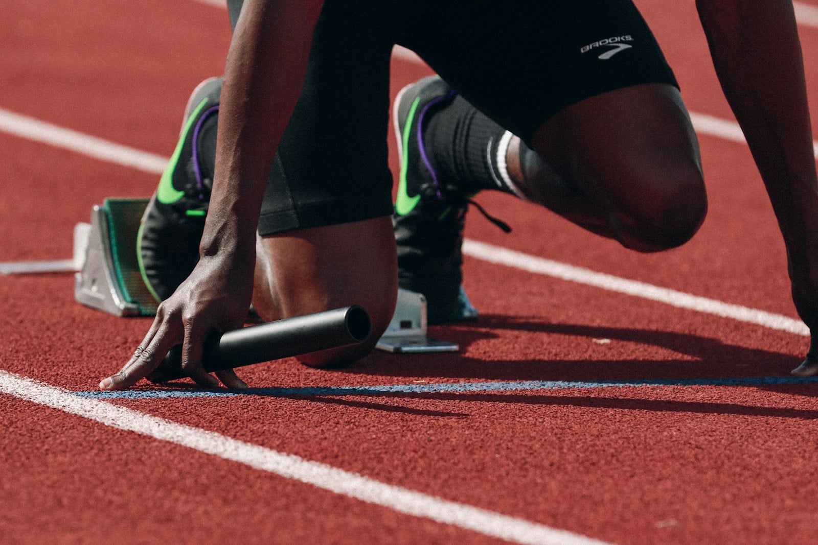 Athlète en position de départ sur une piste d'athlétisme
